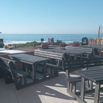 Outdoor benches with sea view at Orcas Beach Pub & Grill